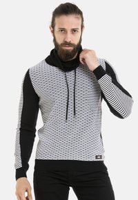 Schwarz-weißer, gemusterter Kapuzenpullover mit einem strukturierten Gewebe-Design, langen Ärmeln und einem gerippften Saum mit Kordelzug-Akzenten.