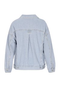 Chaqueta de mezclilla a rayas en azul claro y blanco, con cuello, hombros caídos y botones a presión en los puños y el dobladillo.