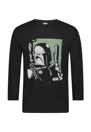 Zwarte T-shirt met lange mouwen met een grafisch ontwerp van een met een helm uitgeruste personage met wapens, tegen een groene achtergrond.