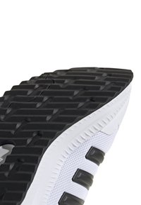 Zapatilla de correr con una suela de goma texturizada negra, parte superior de malla blanca y acentos negros. Presenta ranuras para tracción y flexibilidad.