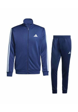 Conjunto de chándal de color azul marino que incluye una chaqueta con cremallera y cuello alzado, adornada con franjas blancas, combinada con pantalones ajustados a juego.