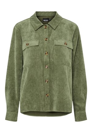 Green corduroy shirt with a collar, two chest pockets, and button closure, featuring a soft texture and vertical ribbed pattern.
