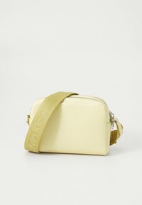 Yellow faux leather bag with a zip closure. Features a tan adjustable strap with logo, and a rectangular shape for easy handling.