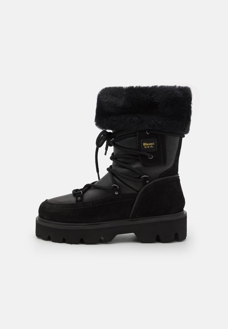 Black winter boots featuring a faux fur cuff, leather and suede materials, a textured surface, lace-up design, and chunky rubber sole.