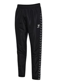 Schwarze Sporthose aus glattem Stoff, mit einem elastischen Bund, schmal zulaufenden Beinen und grauen Chevron-Muster seitlichen Streifen.