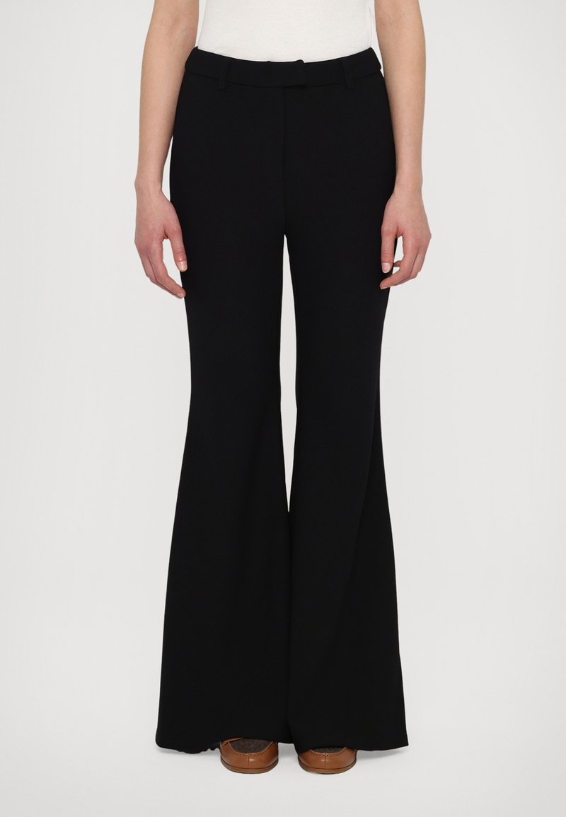 Black flared pants with a smooth, structured fabric; mid-rise waistband and belt loops. Features wide legs extending to the floor.