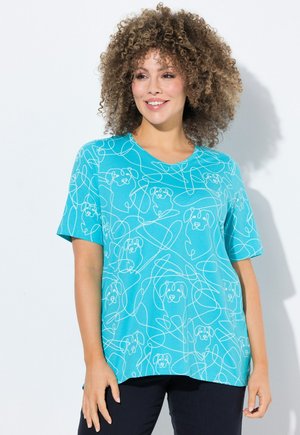T-shirt turquoise à manches courtes avec un dessin en ligne continue blanc représentant des têtes de chien et des tourbillons. Tissu doux avec une coupe décontractée.