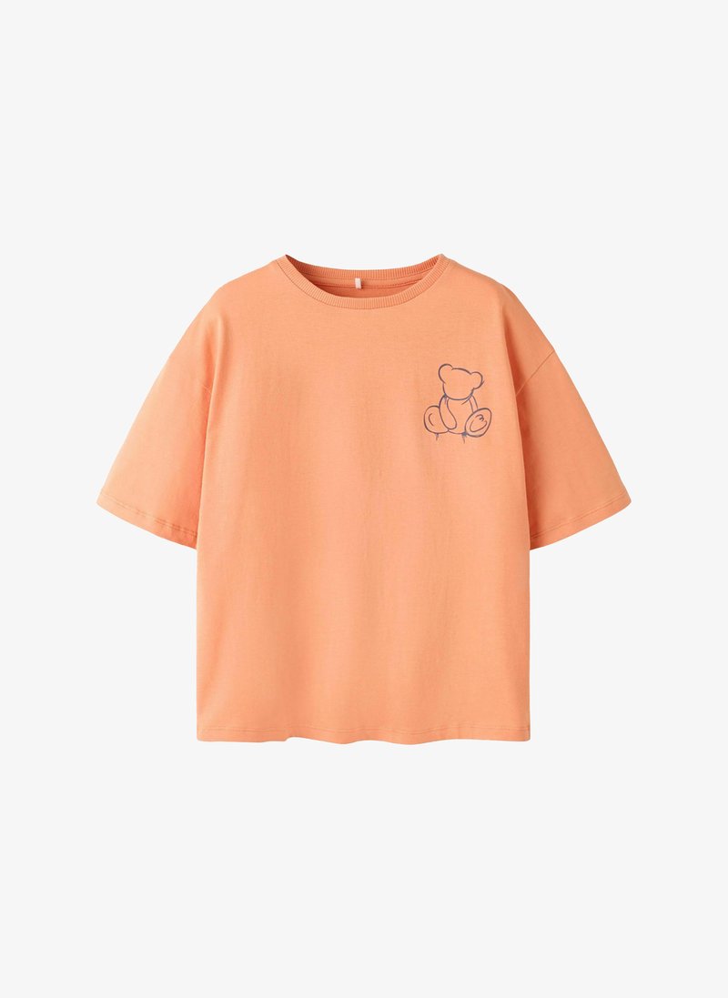 Peach short-sleeve T-shirt with a simple dark line drawing of a teddy bear on the upper left chest.