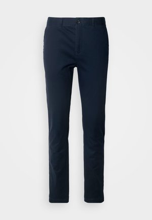 Navy blue chinos made of woven fabric, featuring a front button closure, belt loops, and a straight-leg design with minimalistic styling.