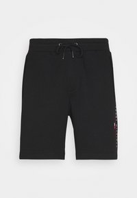 Pantalones cortos de sudor negros hechos de algodón, con cintura elástica y cordón, bolsillos laterales y detalle de logo en un lado.