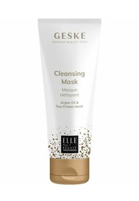 Witte tube met een gouden basis, gelabeld "Reinigingsmasker." Bevat arganolie en soja-eiwit, met gouden spikkels en zwarte tekst.