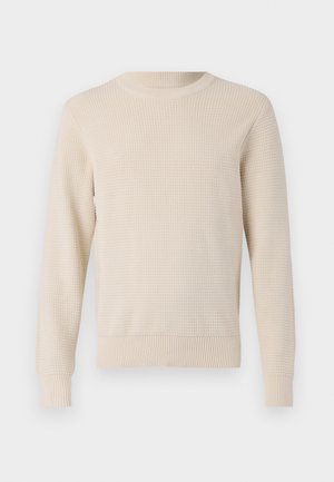 Pull en tricot beige avec un motif texturé, col rond, et poignets et ourlet côtelés. Coupe classique avec des manches longues.