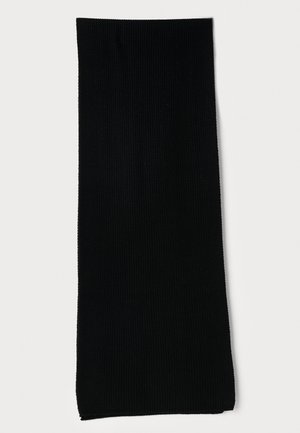 Meia longa preta, com uma textura canelada, feita de material elástico, apresentando uma superfície lisa e uma cor uniforme, sem padrões ou adornos.