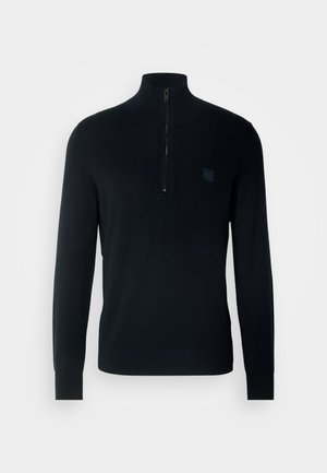 Sötét tengerészkék pulóver kapucnival, félig cipzárral az elülső részen és bordázott mandzsettával. Kicsi logó folt található a mellkason.