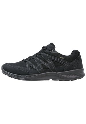 Black low-cut hiking shoe with mesh and synthetic panels, lace-up closure, and Gore-Tex label for waterproof protection.