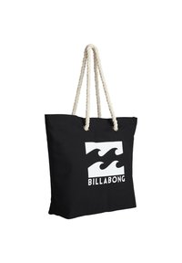 Black tote bag with cream rope handles, featuring a white wave logo and text "BILLABONG" on the front, made of durable fabric.
