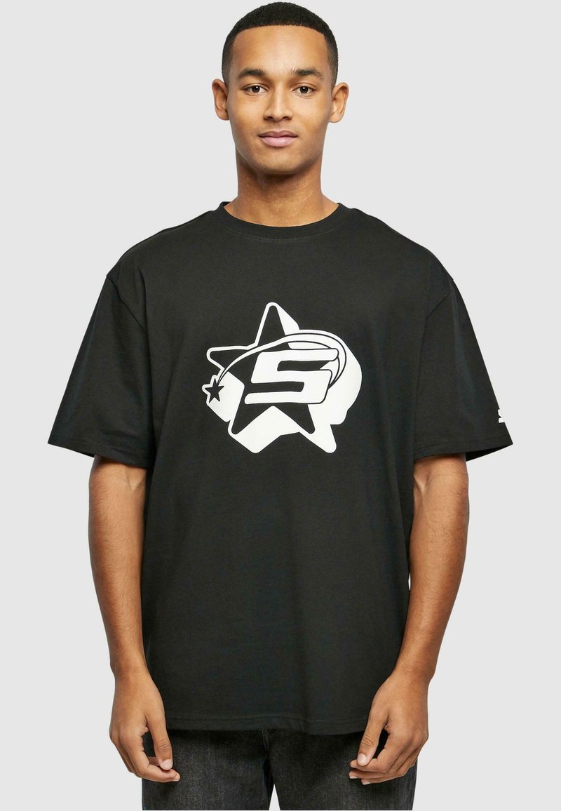 Sort bomulds t-shirt med en stor hvid stjerne og bogstavet "S" i midten. Korte ærmer og afslappet pasform.