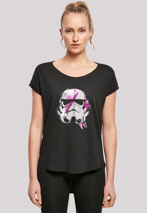 Black short-sleeve t-shirt made of soft fabric featuring a graphic of a stormtrooper's helmet with pink accents on the front.