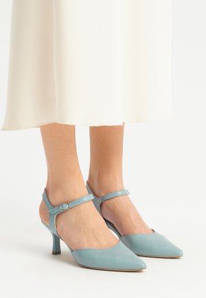Décolleté in pelle azzurra con punta affusolata, cinturino alla caviglia e tacco di 5 cm. Le aperture laterali aggiungono dettagli al design.