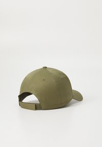 Olive green cap with a curved brim, made from cotton, featuring stitching details, eyelets for ventilation, and an adjustable strap at the back.