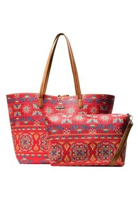 Bolso tote rojo con un estampado y asas de cuero marrón, acompañado de un pequeño estuche a juego. Ambos presentan intrincados diseños florales y texturas.