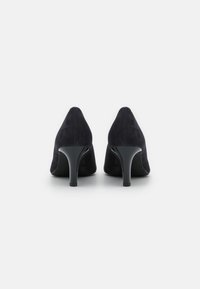Black suede high heel shoes with a pointed toe and glossy black heel, featuring a smooth texture and a minimalist design.