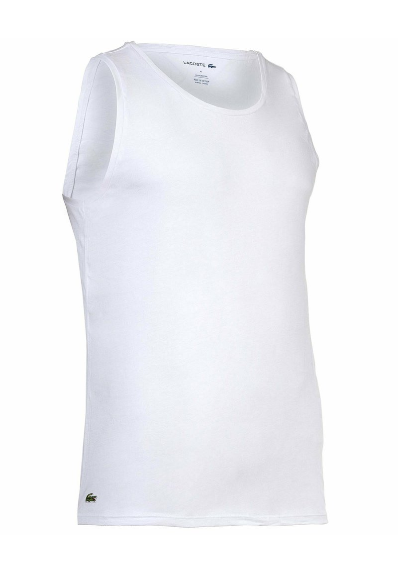 Top senza maniche di cotone bianco con scollatura rotonda e un piccolo logo di coccodrillo verde sul lato sinistro in basso.