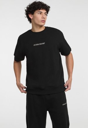Guess Jeans KURZARM - Print T-shirt - schwarz