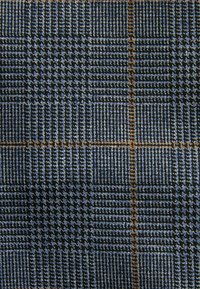 Textile with a blue and gray checked pattern, featuring intricate weaves and subtle orange accents, showcasing varied textures and dimensions.