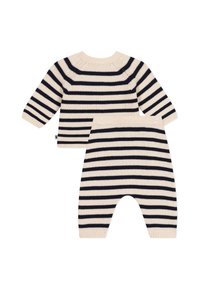 Set di maglieria a righe nei toni crema e navy, composto da un top a maniche lunghe con scollatura tonda e pantaloni abbinati con vita elasticizzata e polsini alle caviglie.