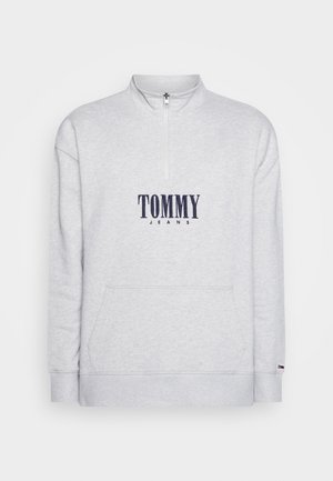 Jasnoszara bluza z suwakiem do ćwiartki, z logo "TOMMY JEANS" w kolorze granatowym na przodzie oraz przednią kieszenią typu kangur.