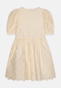 Robe crème légère avec des manches bouffantes, des motifs floraux brodés et des détails découpés. Ourlet festonné et encolure ronde.