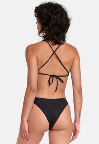 Black bikini set with a crisscross back design, thin adjustable straps, high-cut bikini bottoms, and smooth texture. Ties at the back.