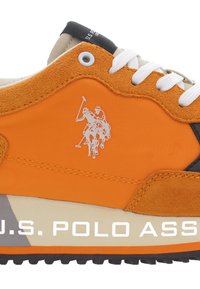 Orange sneaker with suede and synthetic materials, featuring white laces and a logo depicting polo players. Foam sole with black tread.
