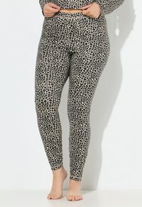 Leggings con stampa leopardata caratterizzate da uno schema di colori nero e beige, tessuto elasticizzato, design aderente e assenza di elementi hardware o decorazioni visibili.