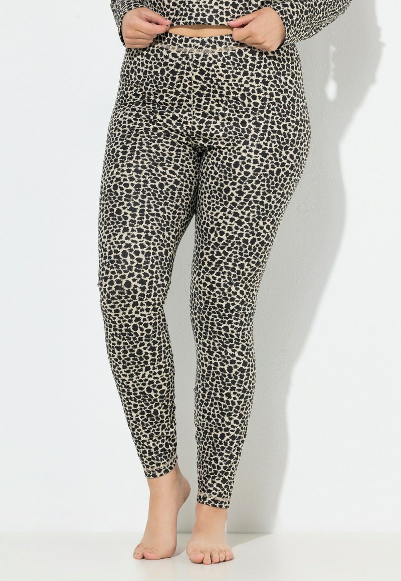 Leggings con stampa leopardata caratterizzate da uno schema di colori nero e beige, tessuto elasticizzato, design aderente e assenza di elementi hardware o decorazioni visibili.