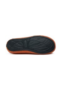 Orange felt slipper with black natural rubber sole. The outsole features textured grooves for grip and comfort, indicating indoor use.
