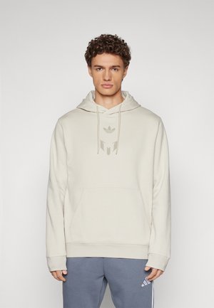 Helle beige Kapuzenpullover mit Kängurutasche, verstellbarem Kordelzug und einem dezenten Logo in der Mitte. Weicher Stoff und lockere Passform.