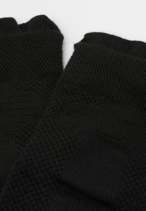 Black knit fingerless gloves featuring textured patterns and ribbed cuffs. Material appears soft and stretchy with detailed stitching.