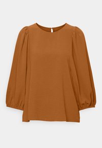 Haut marron, ample, avec manches longues bouffantes, encolure ronde et petite ouverture en forme de clé dans le dos. Texture douce sans motifs apparents.