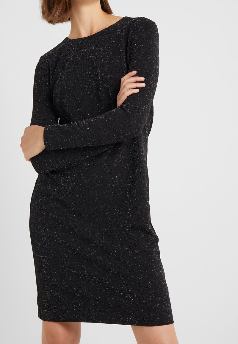 Black long-sleeve dress with a fitted silhouette, made of textured fabric featuring subtle metallic flecks for added detail.