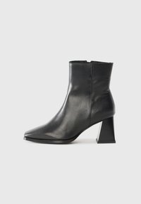 Black leather ankle boot with pointed toe and a chunky, geometric block heel. Smooth texture and minimal design without visible hardware.
