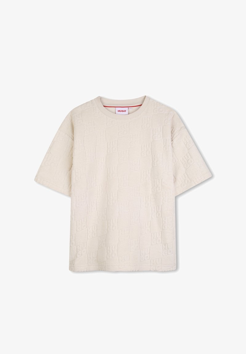 T-shirt beige à manches courtes avec motif du logo Hugo en relief et col rond, présenté sur un fond blanc.