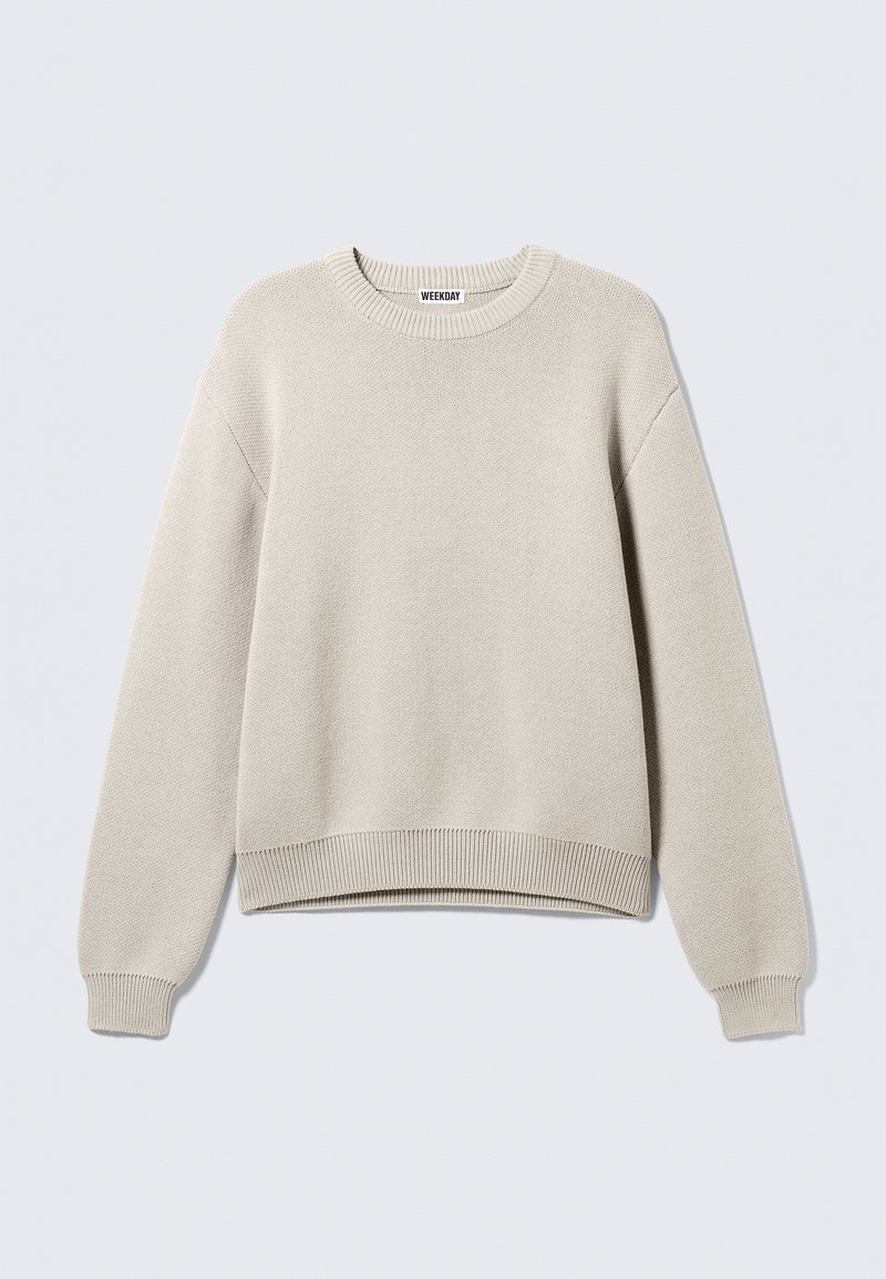 Pull beige clair en tricot, doté d'un col rond, de poignets et d'un ourlet côtelés, avec une coupe décontractée et une conception légèrement raccourcie.