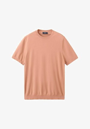 Džemper kratkih rukava s okruglim izrezom u svijetloj breskvastoj boji, jednobojni dizajn s rebrastim ovratnikom, manžetama i rubom, prikazan položen na bijeloj pozadini.