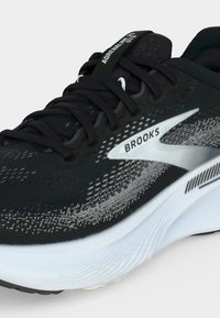 Black and gray Brooks Adrenaline GTS running shoe with white sole and black laces, showing side logo and part of the tongue label.