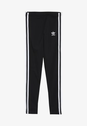 Leggings negros de material elástico con franjas blancas laterales y un pequeño logo blanco de Adidas en el frente.