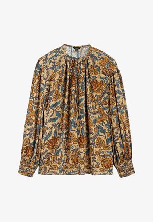Blouse beige à manches longues avec des motifs floraux et de feuilles bleus, bruns et orange, col et poignets froncés.