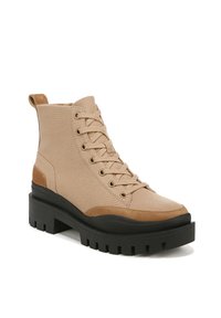 Beige canvas ankle boot with brown suede accents, round toe, gold eyelets, sturdy black rubber platform sole, and a pull tab at the heel.