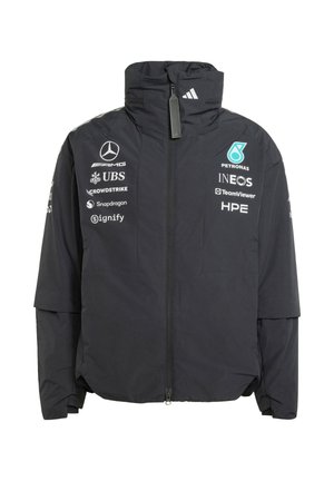 Veste noire zippée avec col haut arborant les logos Mercedes, Petronas, INEOS et d'autres sponsors sur le devant et les manches.